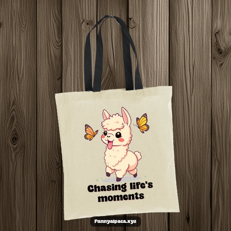 Funny tote bag depicting a playful alpaca with its tongue sticking out, chasing a butterfly, a symbol of joyous pursuit.